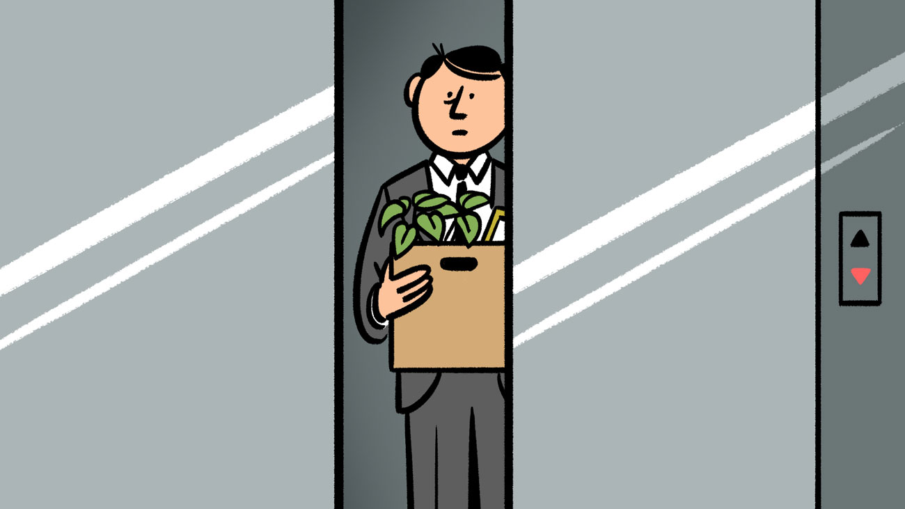 Man in a suit holding a box in an elevator